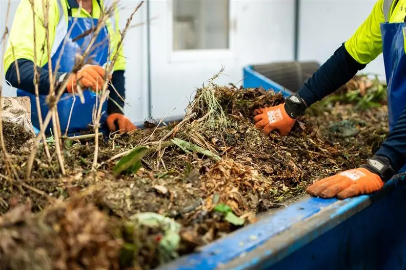 <p>HANDY WORK: Council staff sort green waste destined to become compost.</p>\\n