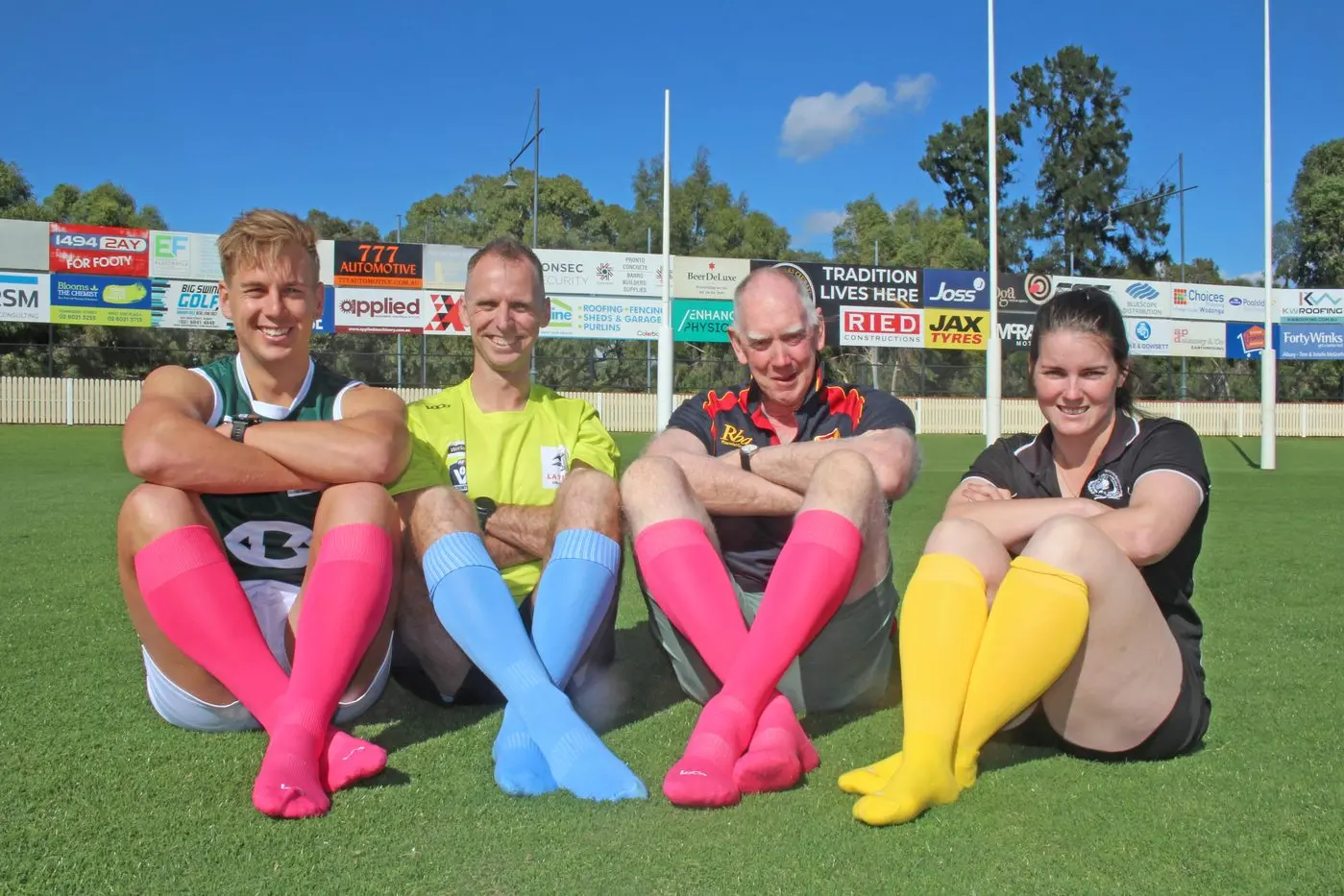 STRIKING SOCKS: Ovens and King Football Netball League manager Cam Green, AFL North East Border umpires manager Michael Bocquet, Terry Greaves, and Wangaratta Magpies netball co\\u2013coach Chaye Crimmins donned coloured socks to promote local cancer awareness. PHOTO: Albury Wodonga Regional Cancer Centre Trust Id:22923