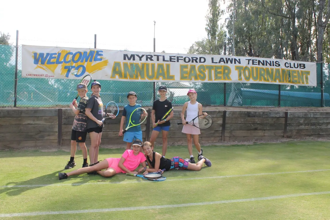 READY FOR ROUND ONE: Local tennis players (from left, back row) Quinn and Iza Montgomery, Spence Reynolds, Lexie Piazza, Summer Milne, (from left, front row) Harriet Earl and Mackenzy Reynolds can\\'t wait for this year\\'s Easter Tennis Tournament, with the majority participating in their first year of matches. PHOTO: Phoebe Morgan