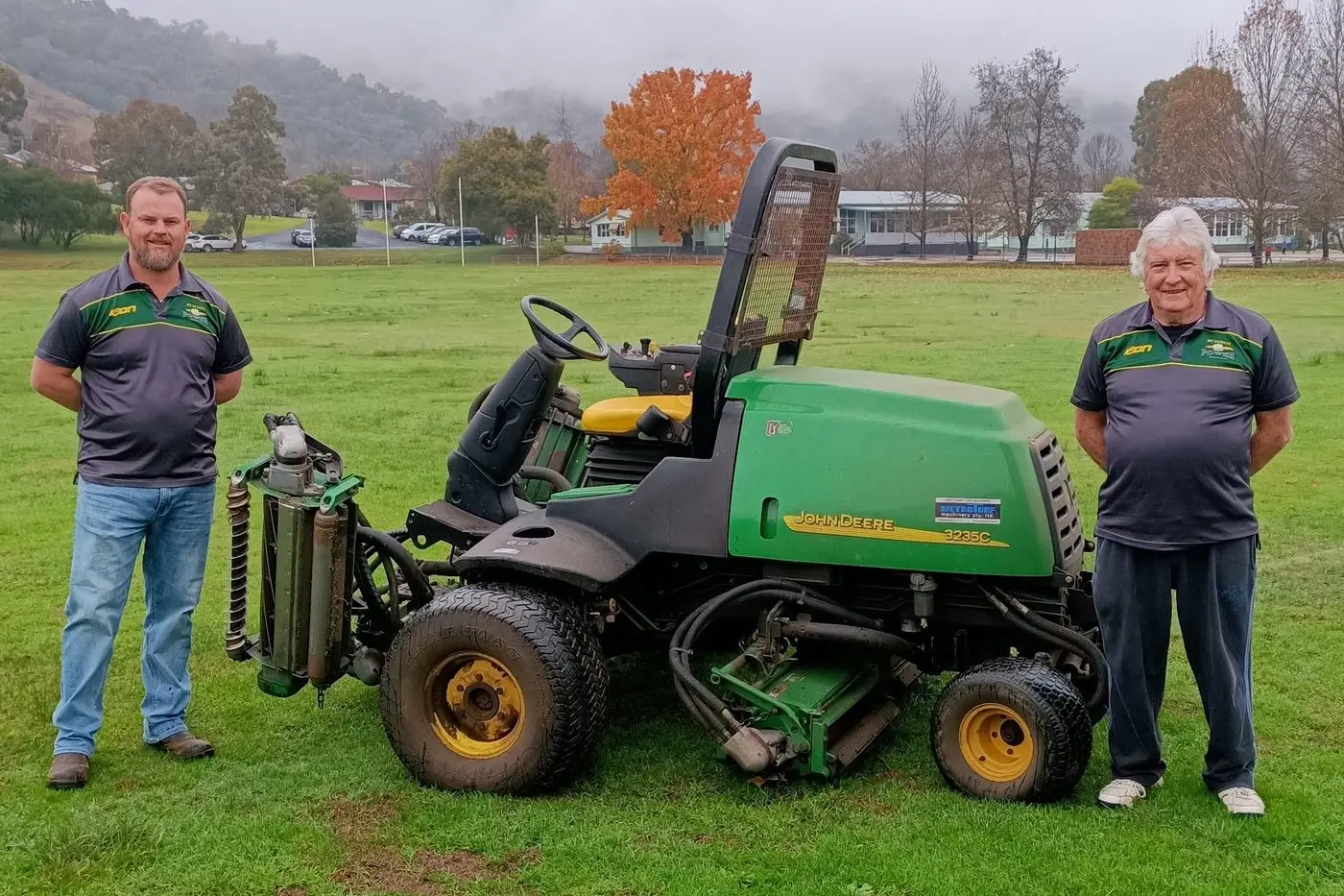 STEPPING DOWN: Ross Wilson, pictured left with Kevin Vale and the new mower, has stepped down as president of the Mt Beauty United Cricket Club after seven years in the chair.