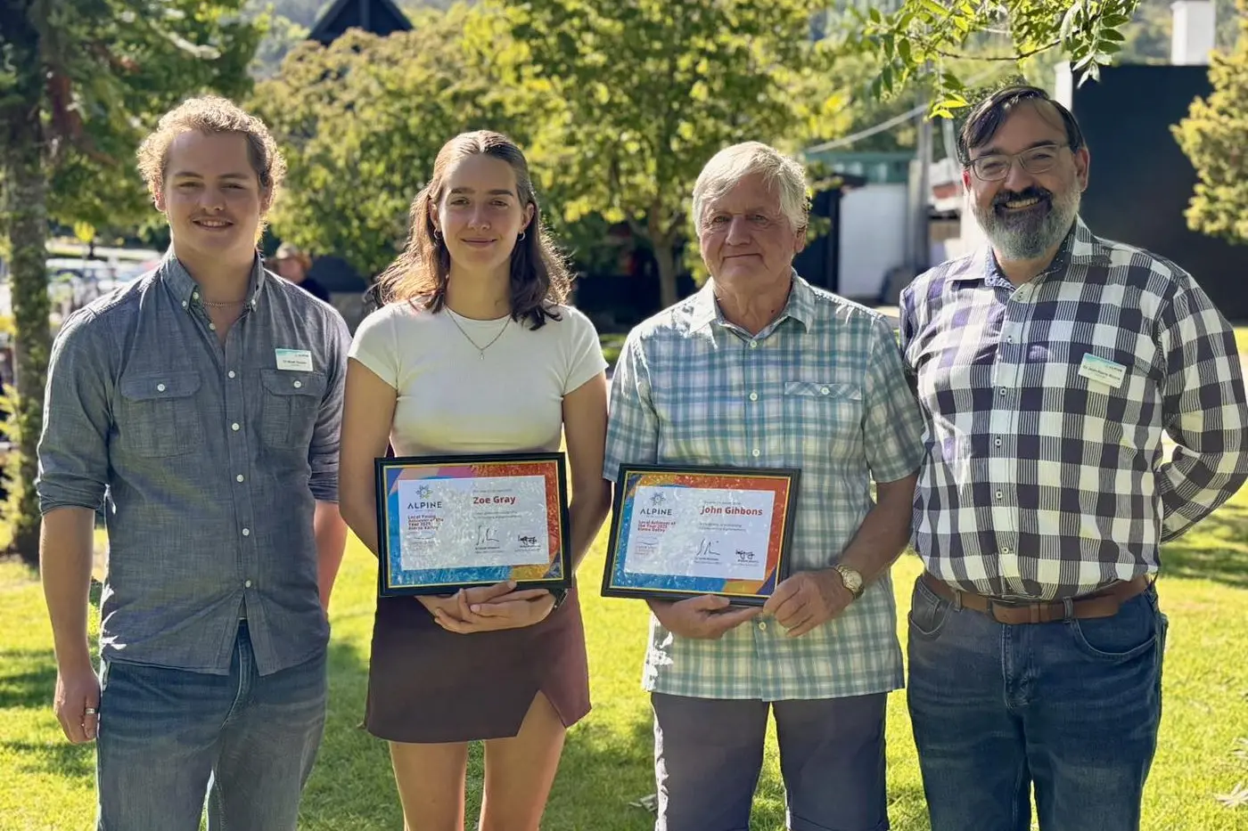 ALPINE ACHIEVEMENTS: (Far left, far right) Alpine Shire Councillors Noah Tanzen and Jean-Pierre Ronco congratulated Kiewa Valley Local Achievers Zoe Gray and John Gibbons on receiving their awards at Sunday\\'s ceremony in Mount Beauty.