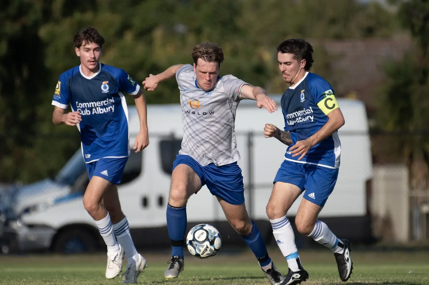 TWO TO BEAT: Will Keenan fends off challenges from a pair of Albury City players in Myrtleford\\'s 4-2 win on Sunday. Savoy will replay City in the FA Cup final on Saturday, May 10. PHOTO: Melissa Beattie