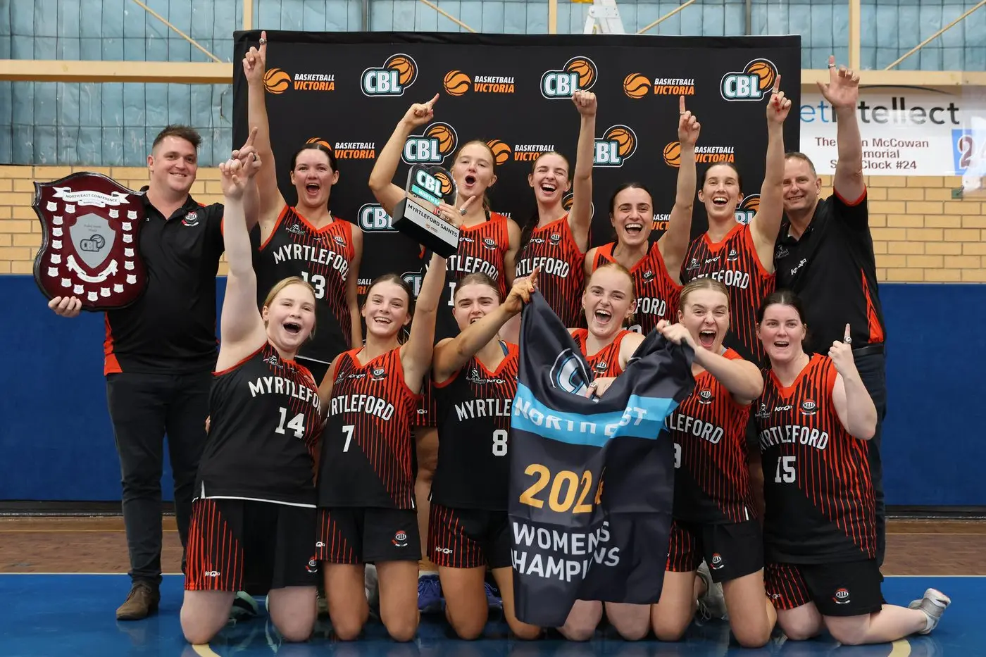 UNDEFEATED: Myrtleford Saints\\' championship winning side (back from left) Kory Batt (coach), Jordan Crisp, Chloe Elliott, Mikayla Cole, Paige Zamperoni, Emma Sharp, Marty Hughes (team manager/assistant coach), (front from left) Makiah McCallum, Evie Hughes, Jorja Reidy, Taylah Reidy, Ava Brock, Chaye Crimmins. PHOTOS: Janet Watt