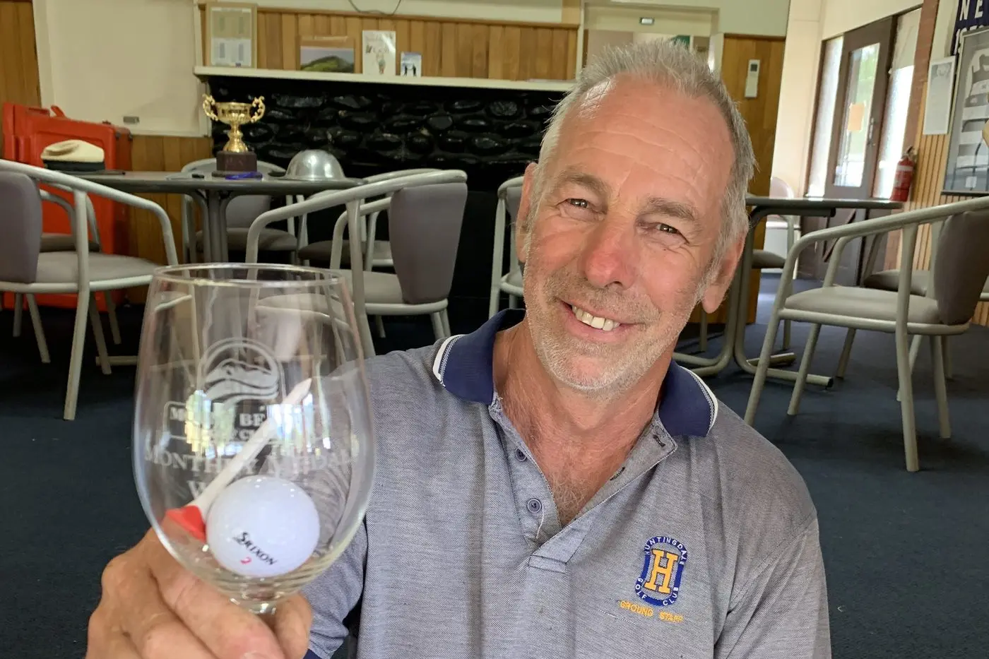 CHEERS: Dave Browning with his glass and ball after the Monthly Medal match at Mount Beauty.