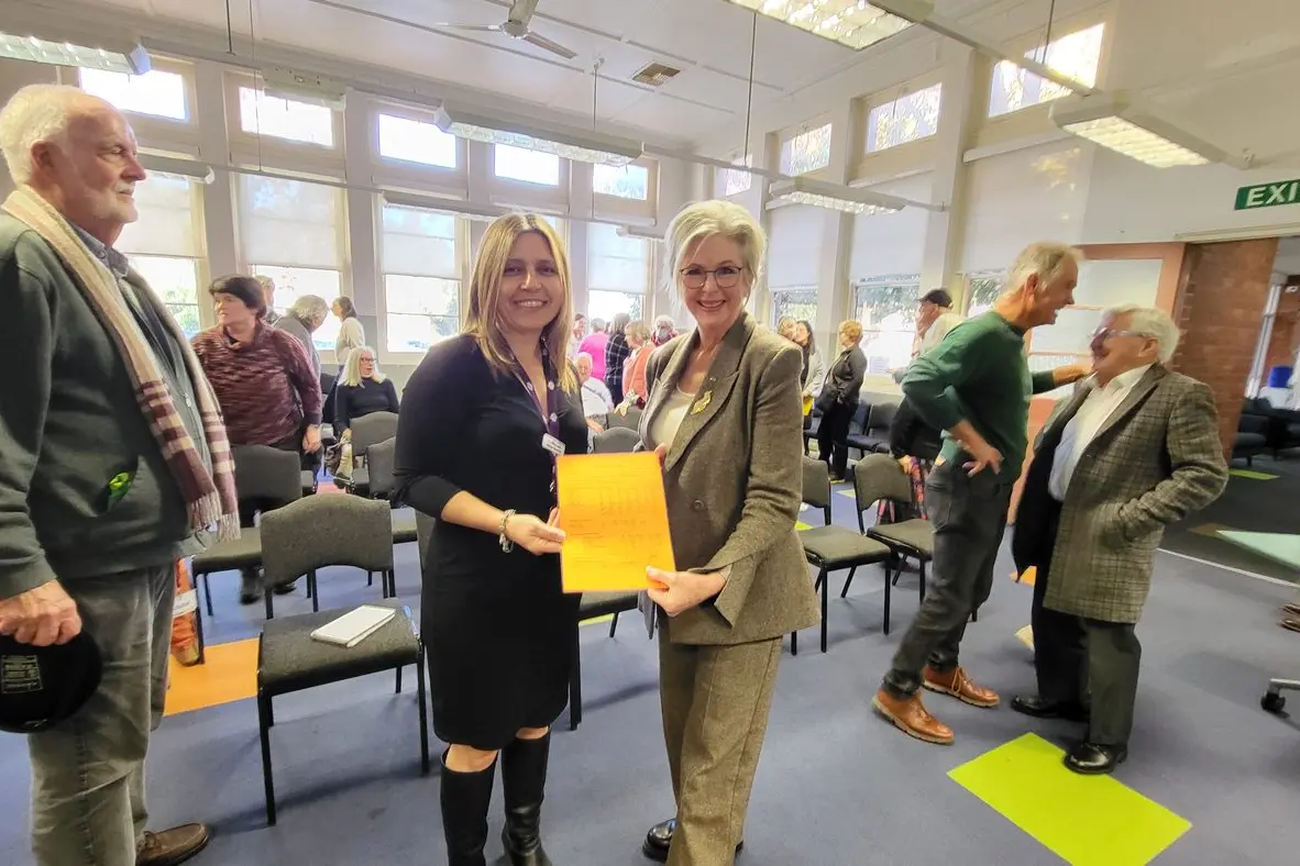 OUTCOME: Australian Electoral Commission divisional returning officer Deborah Giosserano (left) hands a list of the official results to Indi MP Helen Haines fittingly printed on orange paper. PHOTOS: Steve Kelly