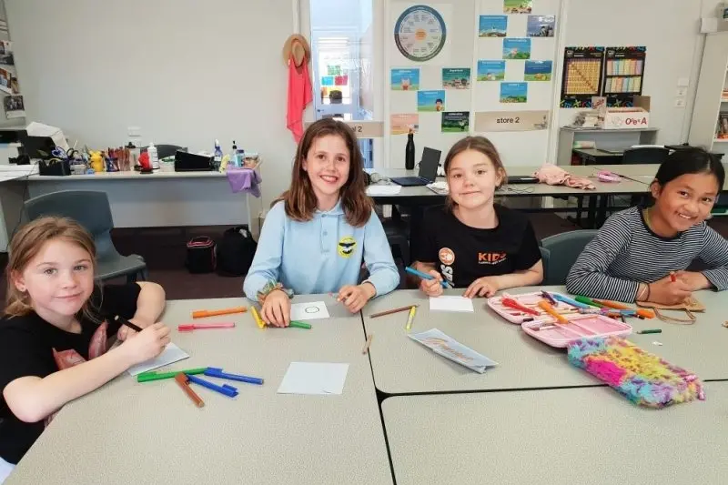 PROUD AS PUNCH: Bright P-12 College students Taylor, Josie, Audra and Samantha decorating the bags and cards for the senior students who are remote learning.