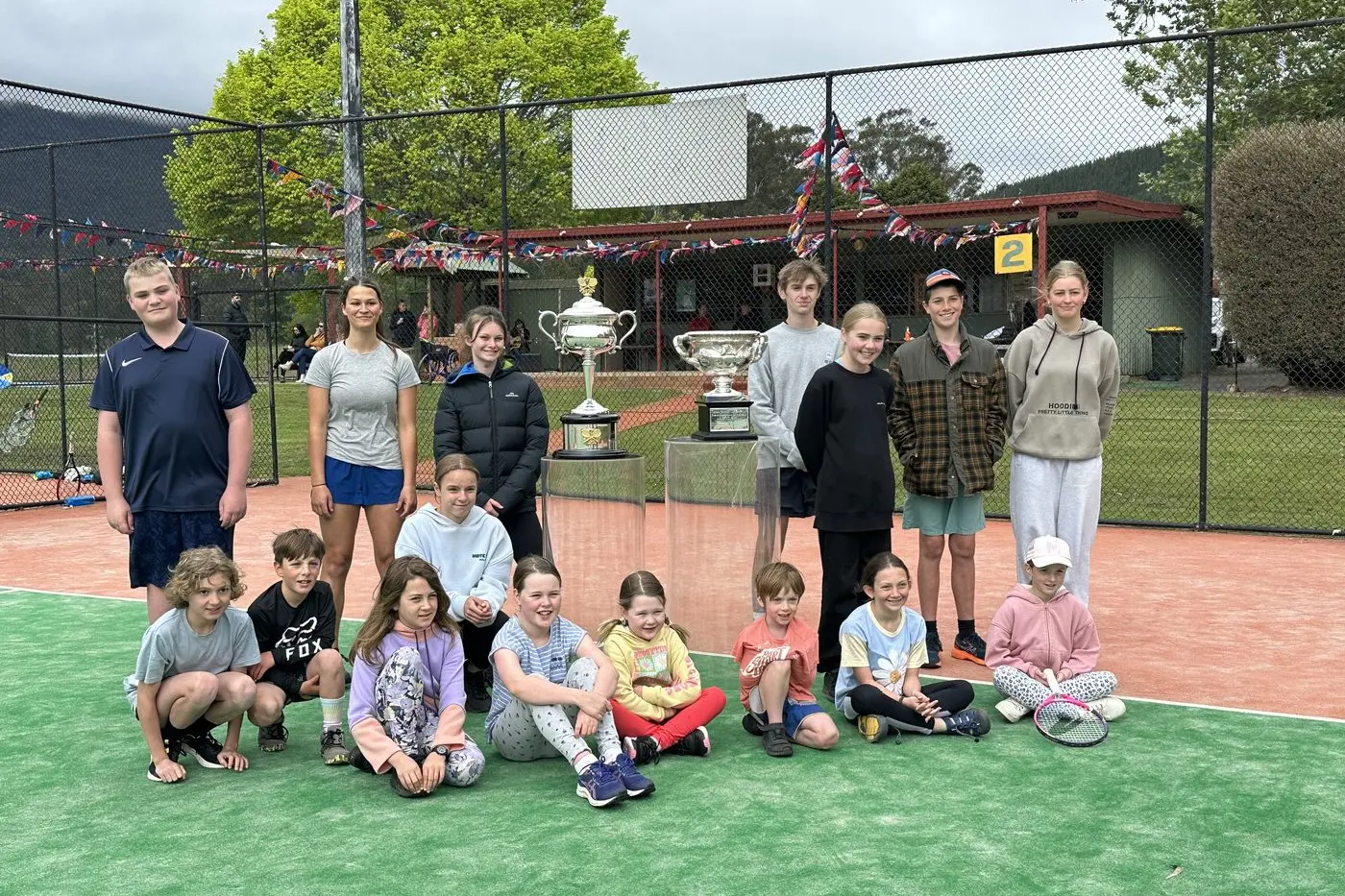 SHINING SILVERWARE: Bright Tennis club members (beck, from left) Harry Dudley, Edith Cafe, Renae Blake, Tom Russell, Tilly Dudley, Audie Whyte, Amelie Thompson, (front, from left) Oscar Ford, Fergus Porter, Erica Blake, April Yarwood, Heidi Yarwood, Elliot Porter, Penny Blake, and Mia Stephens with the Australian Open silverware.
