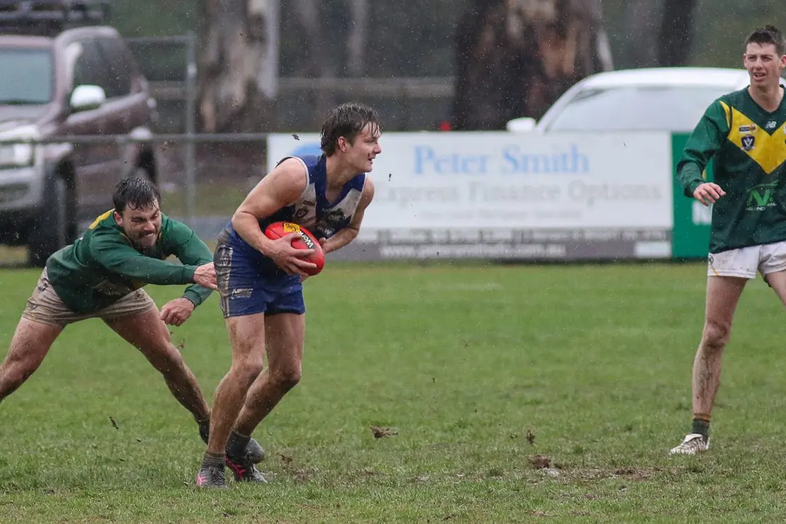 A SLOG: Cooper Thomason moves forward in muddy conditions in the Mountain Men\\'s convincing win over Moyhu. PHOTOS: Richard Xerri