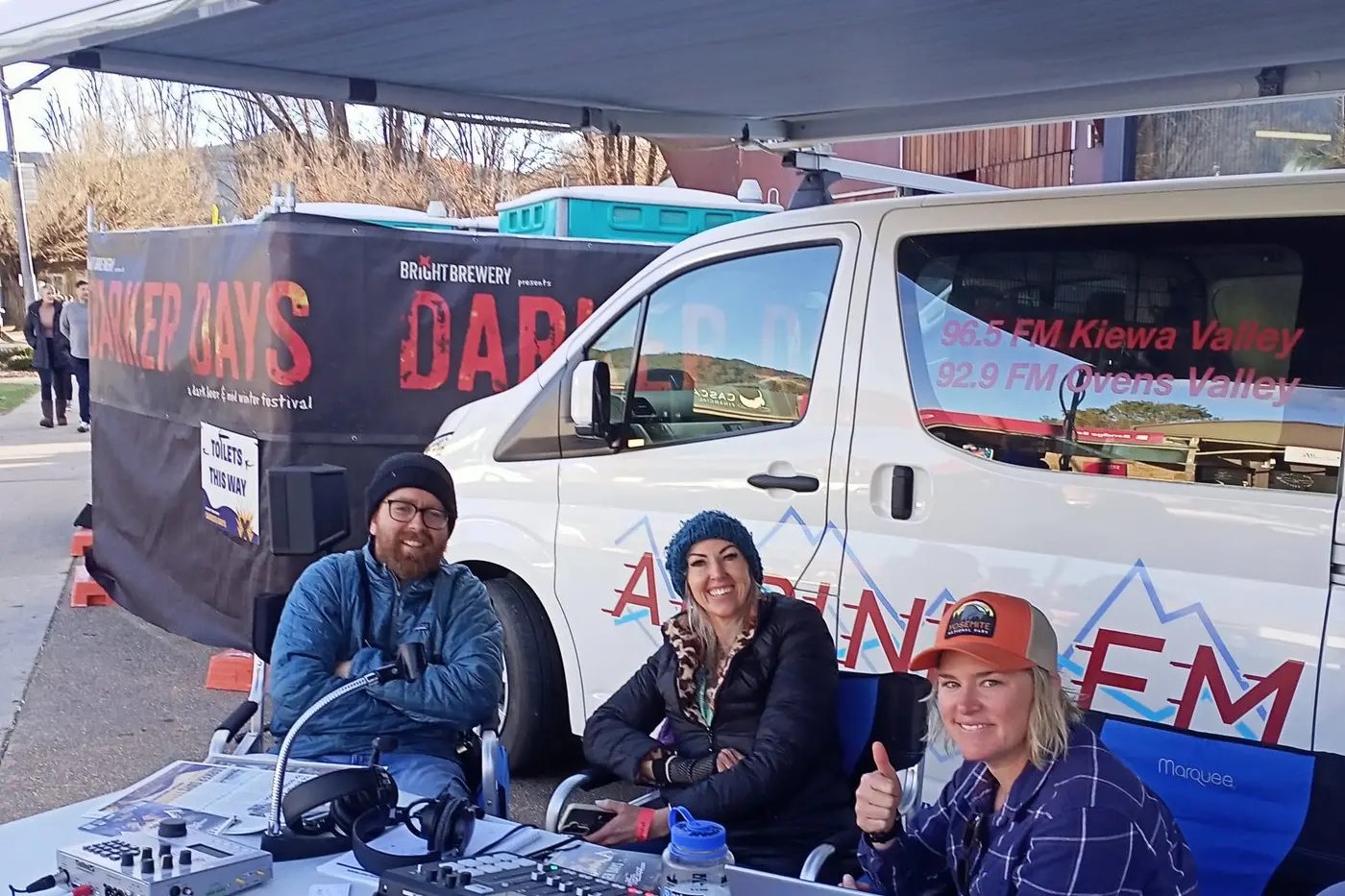 OPEN-AIR RADIO: (From left) musician Matt Siers with presenters Mel Naismith and Mandy Van Gastel at Alpine FM\\u2019s outdoors broadcast from Darker Days last weekend. PHOTO: Michael Ahearn.