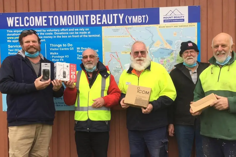 TUNED IN: iCom distributor Tim Roberts (left) personally handed over the two radio units that will help maintain safe skies over Kiewa Valley to KVM members Dennis Neumann, Les Jordan, Bruce Vine, and  Pip Armitage.
