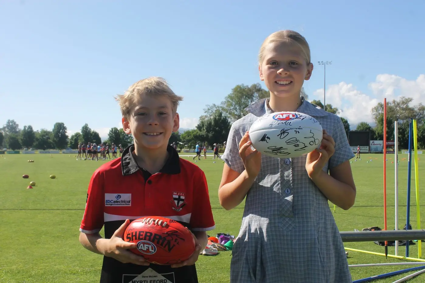 LUCKY LOCALS: Bowie and Goldie Cartwright were among dozens of local schoolkids who were able to meet and get autographs from their favourite Demons at Myrtleford\\'s McNamara Reserve.
