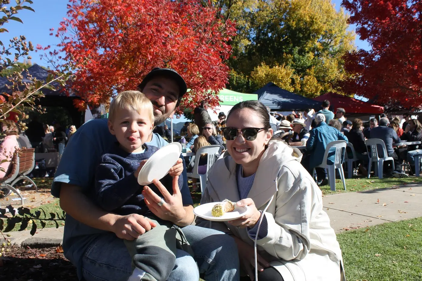 SWEET TREAT: Massimo Giupponi, Michael Ferraro and Laura Rositano made sure to enjoy an iconic dessert from a nearby stall at \\'Il Mercato\\' on Sunday. PHOTOS: Phoebe Morgan