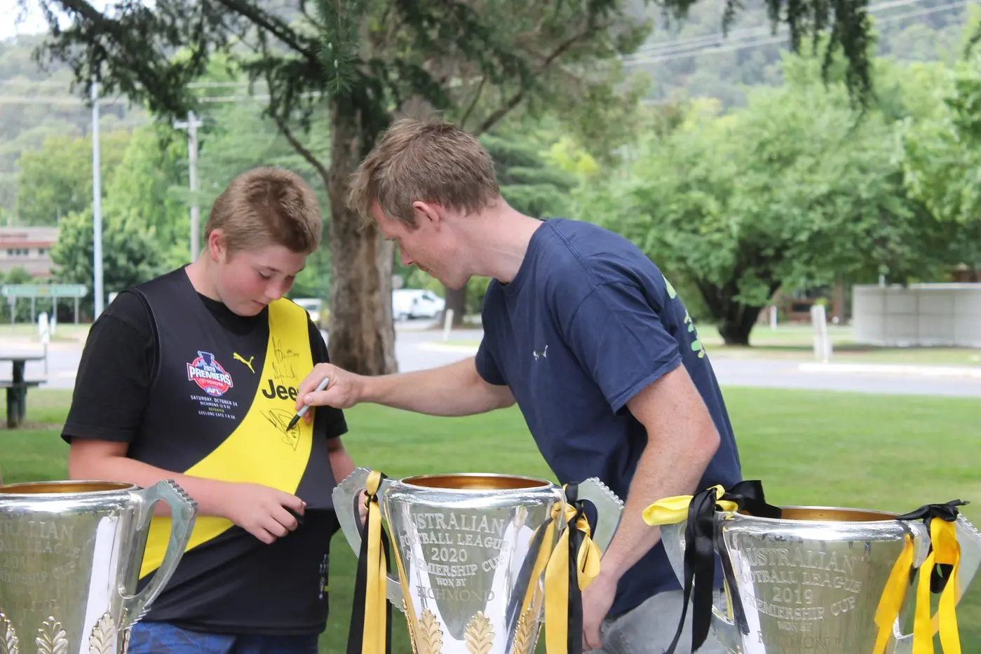 DREAM COME TRUE: Alpine local and diehard Richmond fan, Alan Grasser, was lucky enough to get his Richmond jersey signed by premiership star Jack Riewoldt. Players, coaching and support staff were in Bright last week for a pre-season camp, much to the delight of locals. Full story page 23. PHOTO: James Robinson