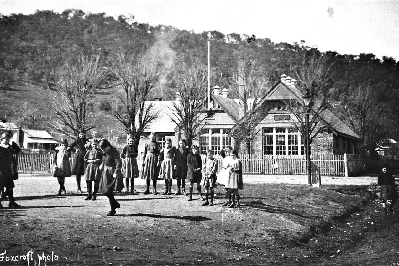 MYRTLEFORD STATE SCHOOL PLAYTIME, 1920: At recess time, girls play a game of hopscotch in the \"playground\" at the corner of Albert and Elgin Streets. Id:31570