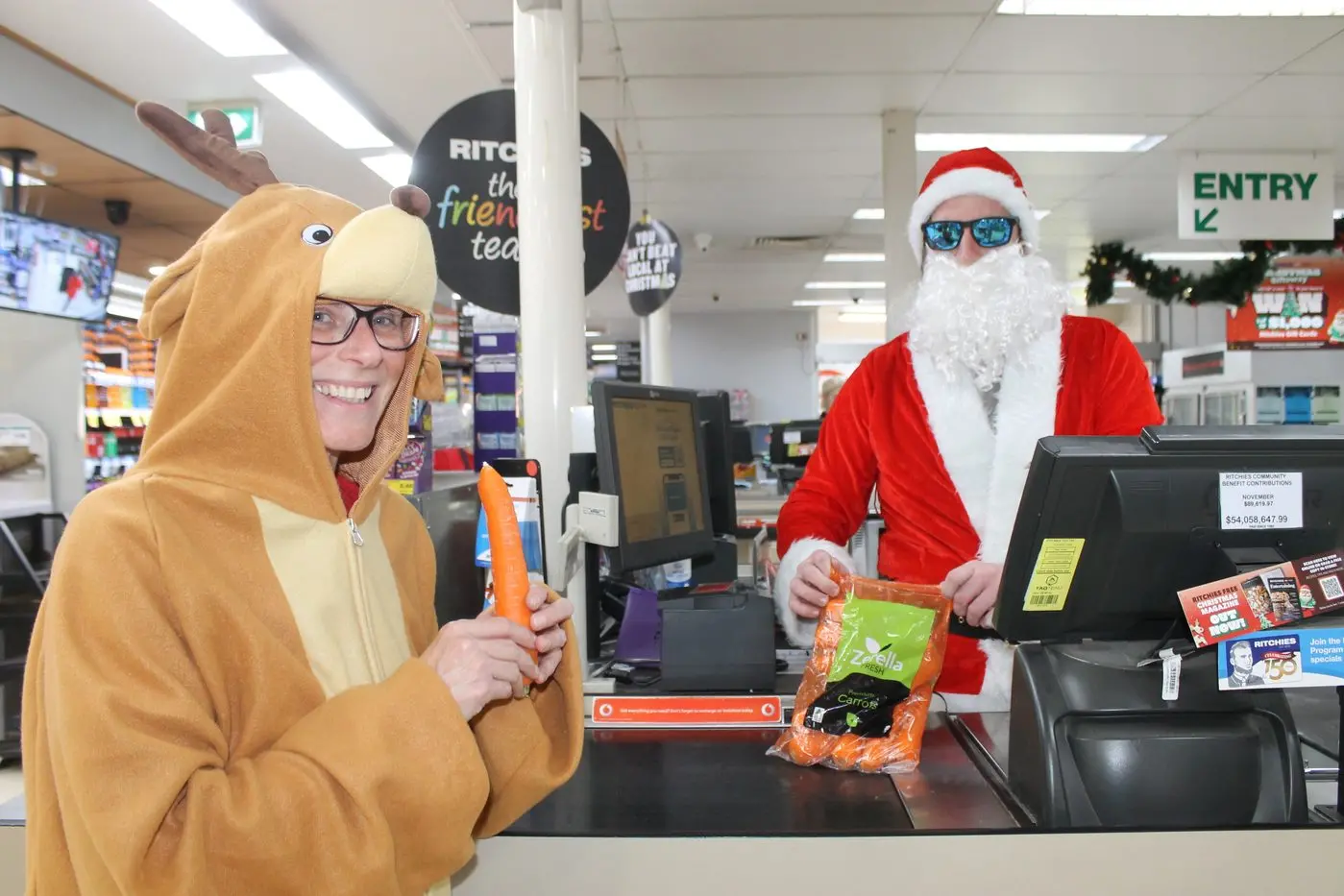 SEASONAL SHOP: Santa helps Clare the Reindeer put through a bag of carrots at Ritchies IGA to prepare for their annual flight.