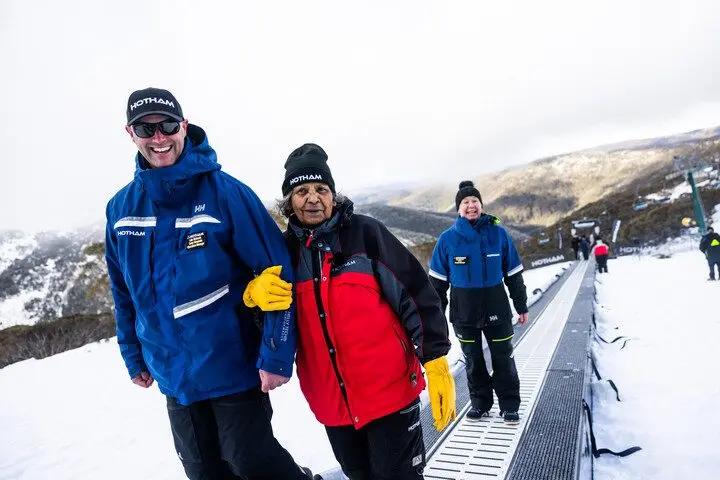 OPENED: Mt Hotham senior mountain operations manager Luke Rickards and Gunai elder Sandra Patten ride the Bunderool Carpet. PHOTO: Mt Hotham Ski Lifts