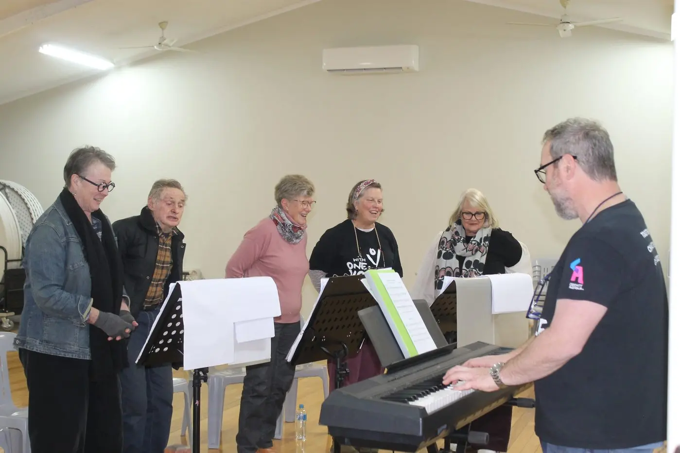 JOIN THE CHORUS: Myrtleford\\'s With One Voice Choir (from left) Ruth Davenport, Russell Peters, Rae Walker, Jen Balnaves and Andrea Howell, with conductor, Jo Davis, sang their way through the songbook at last week\\'s rehearsals. PHOTO: Phoebe Morgan