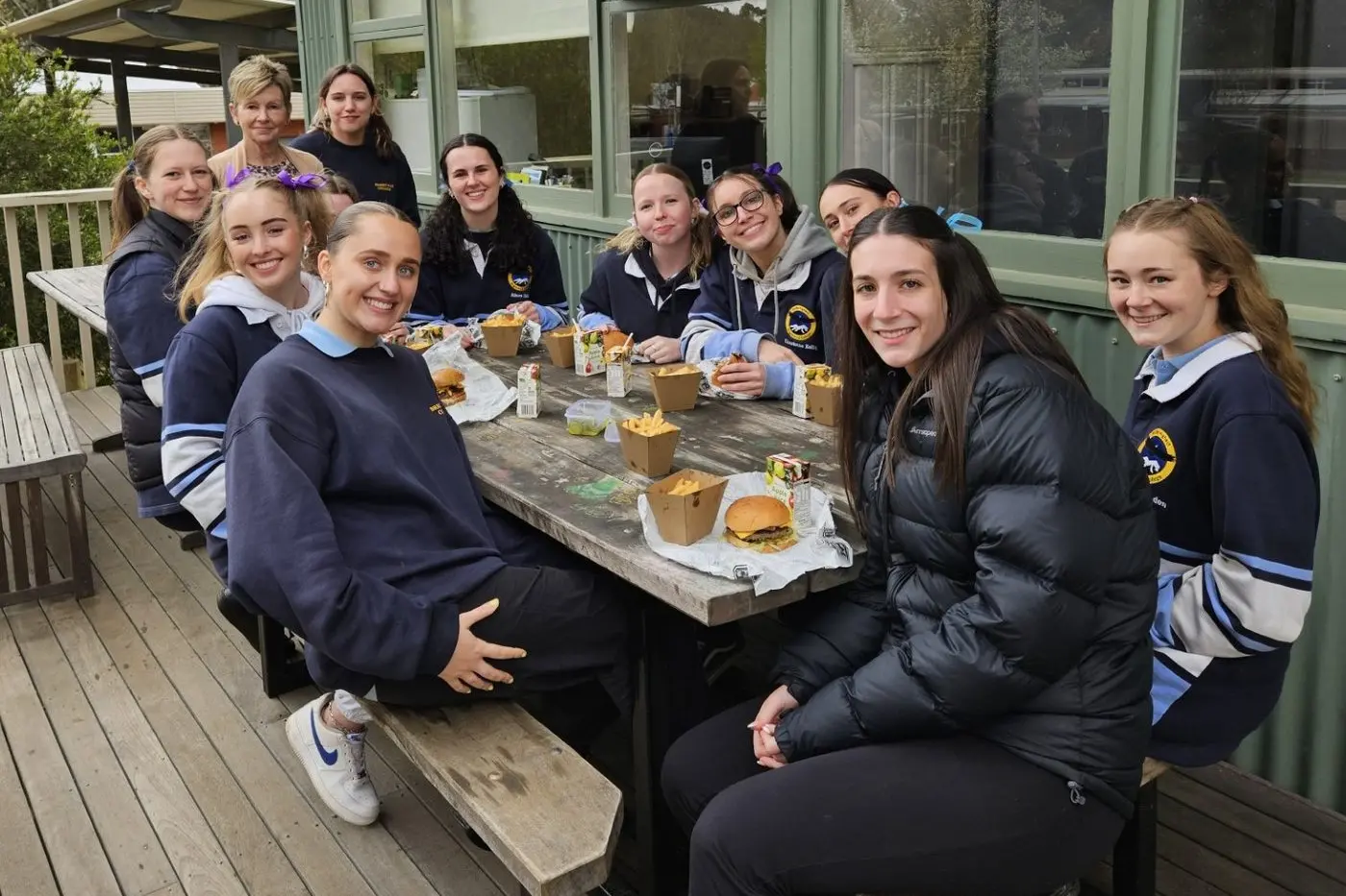 BURGER BREAK: Pictured enjoying a well earned bruger break are (from left, standing at the back) Bright Lion\\'s Club representative Jenni Sgambelloni and Talia, (from left, seated) Kira, Madeline, Molly, Alison, Daisy, Charlotte, Tui, Lilly and Krista.