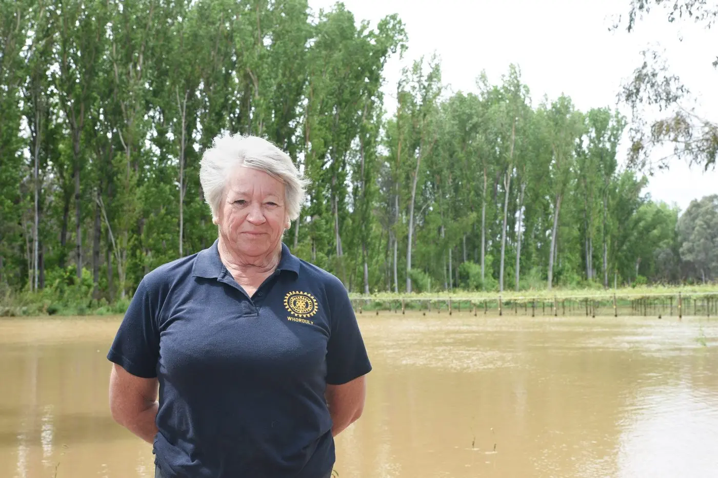UNDER SEIGE: Glenys McNamara stands in front of a section of the kiwifruit orchard that is under water. PHOTO: Kurt Hickling  Id:33824