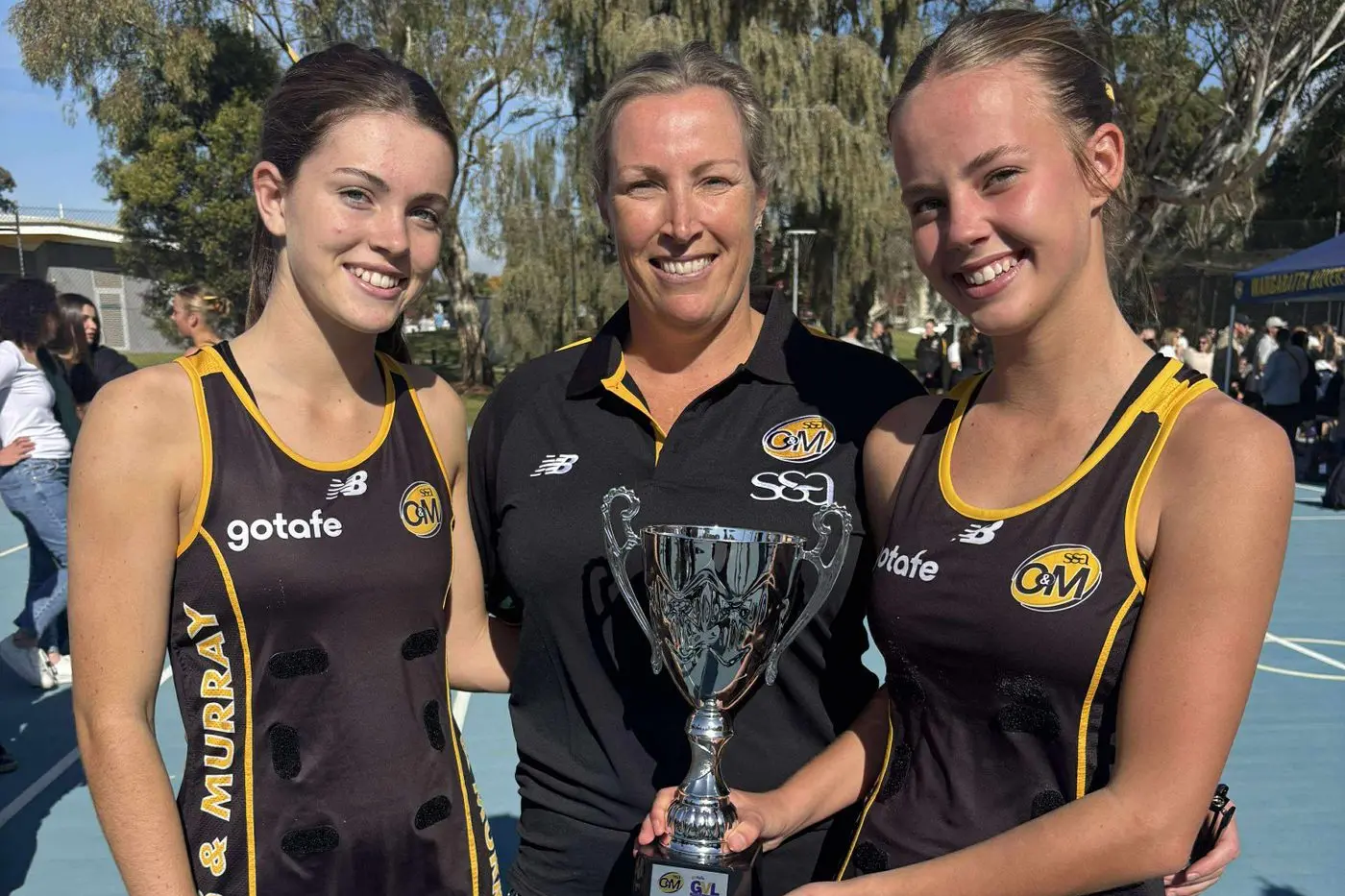 WINNERS ARE GRINNERS: Gemma Corcoran (left) Bridget Flint-Chapman and Zahra Hazeldine helped the O&M under 15s to glory at Wangaratta on Saturday. PHOTO: Myrtleford FNC