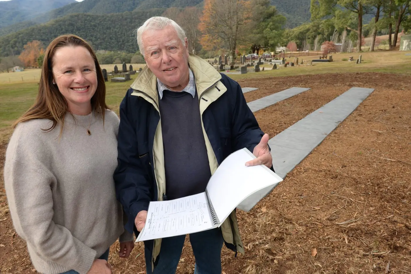 WORKS COMPLETE: Harrietville Cemetery Trust trustee Jo Parker and chair Doug Humphries at the new \\'Pine Lawn Section\" of the cemetery. PHOTO: Brodie Everist 
