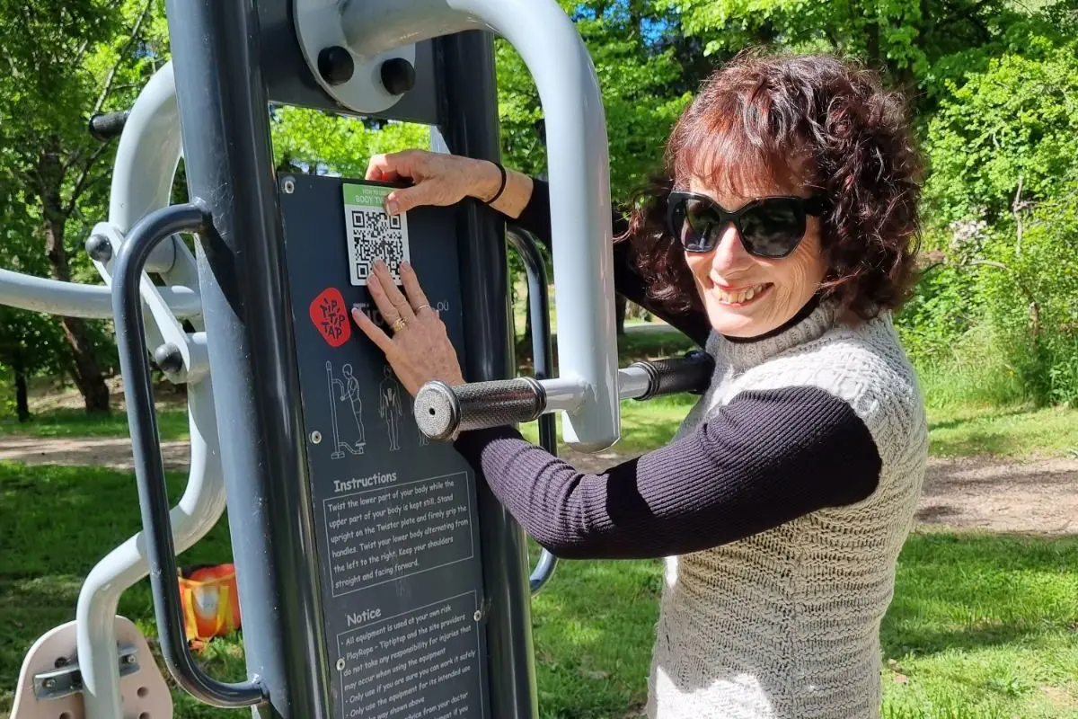 CODE\\'S UP: Robyn Downey, from the Harrietville Community Forum, with one of the new codes adorning the outdoor fitness equipment near Pioneer Park. 