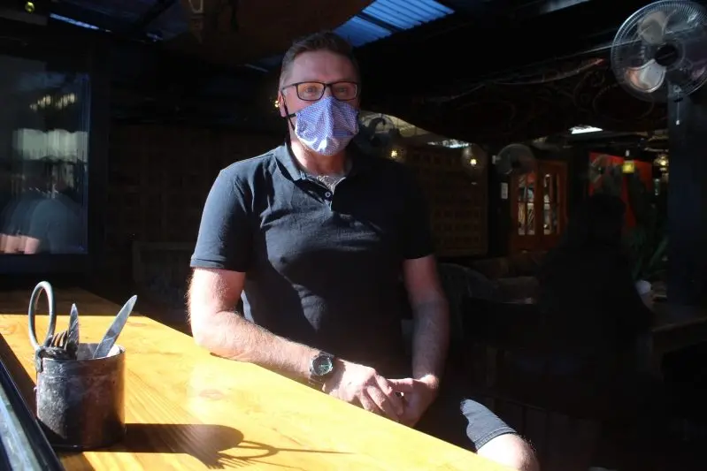 SAY NO TO MELBURNIANS: New COVID-19 restrictions, announced on Sunday, mean anyone wanting to sit in local hospitality businesses will need to prove they haven\\u2019t travelled from Melbourne before they are allowed to dine in. Hospitality workers like Myrtleford\\u2019s Caf\\u00E9 Fez supervisor, Graeme Scott, will wear the responsibility or risk a $10,000 fine. PHOTO: Ashleigh Piles