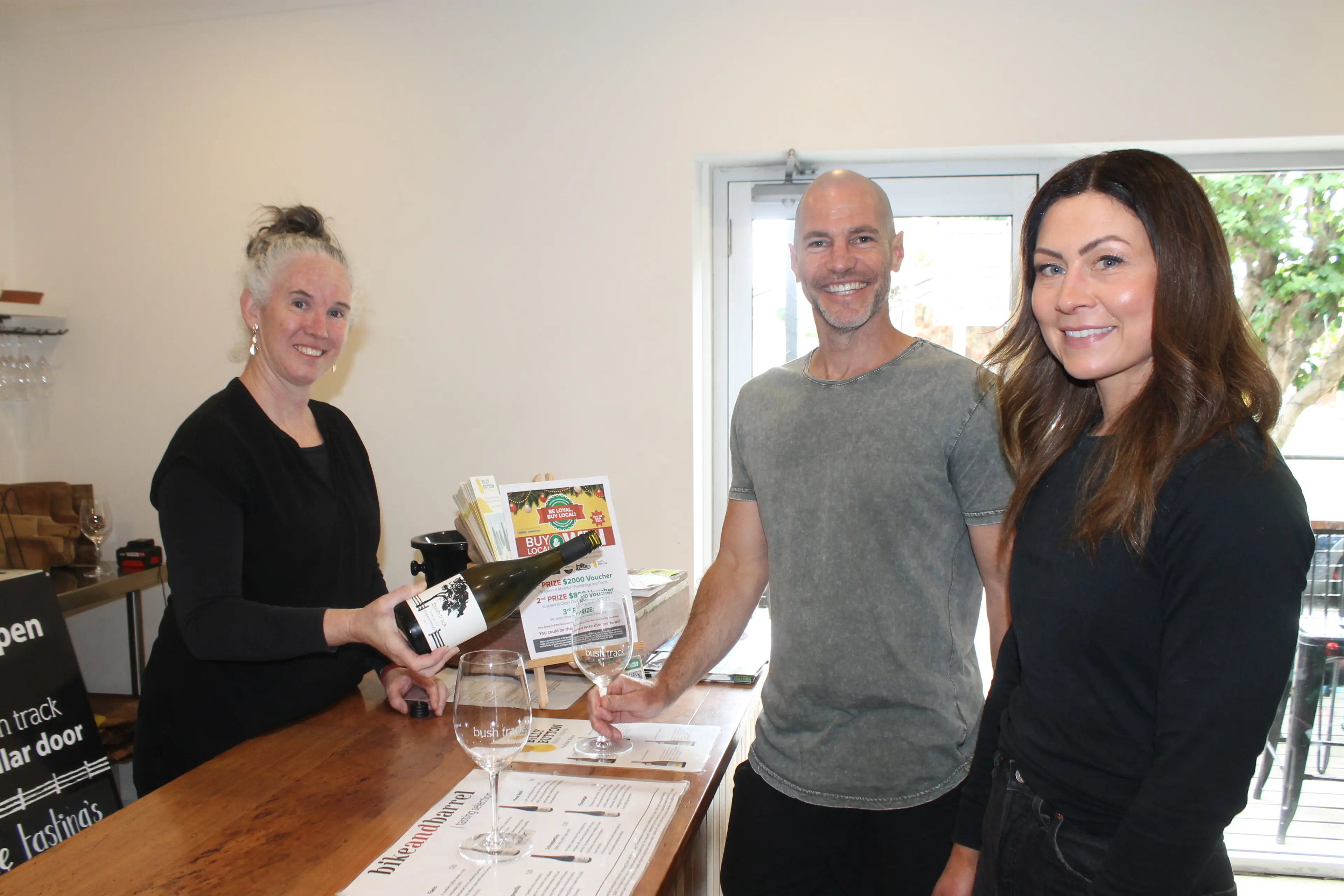 <p>CHRISTMAS CHEERS: One of the businesses involved in this year\\'s \\'Buy Local and Win\\' promotion, Bush Track Wines in Myrtleford, is a perfect place to find the best pairing for festive functions, as sales attendant Carly Montgomery at BTW cellar door offered a test glass of Chardonnay to Mark and Kylie Eaton from Melbourne. PHOTO: Phoebe Morgan</p>\\n