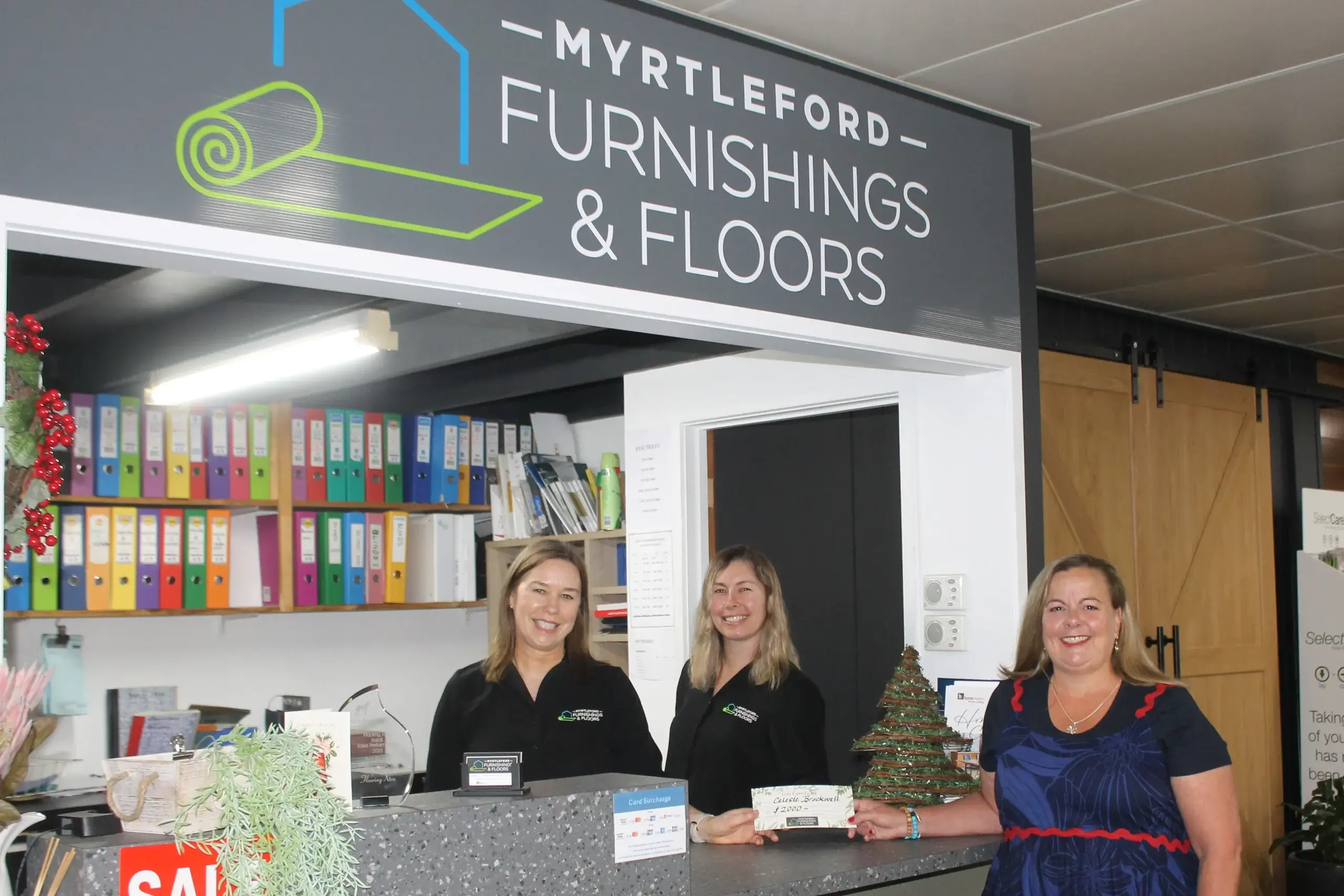 <p>CHRISTMAS CERTIFICATE:  Myrtleford Furnishings and Floors co-owners (from left) Janine Botter and Sheridan Hill presented Celeste Brockwell with her first-place prize from this year\\'s \\'Buy Local and Win\\' promotion. PHOTO: Phoebe Morgan</p>\\n