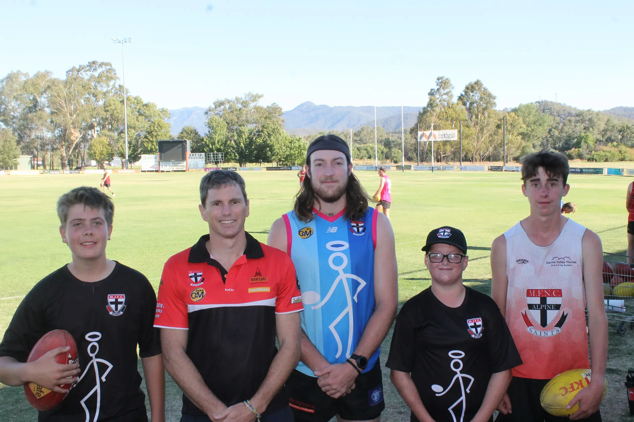 <p>COME TOGETHER: Junior and senior footballers will come together on the upcoming community day, with (from left) Tex Cartwright, MFNC president Luke Chapman, Riley Smith, James Tilson and Ashton McManus standing united and showing the width of the sport in Myrtleford. PHOTOS: Phoebe Morgan.</p>\\n
