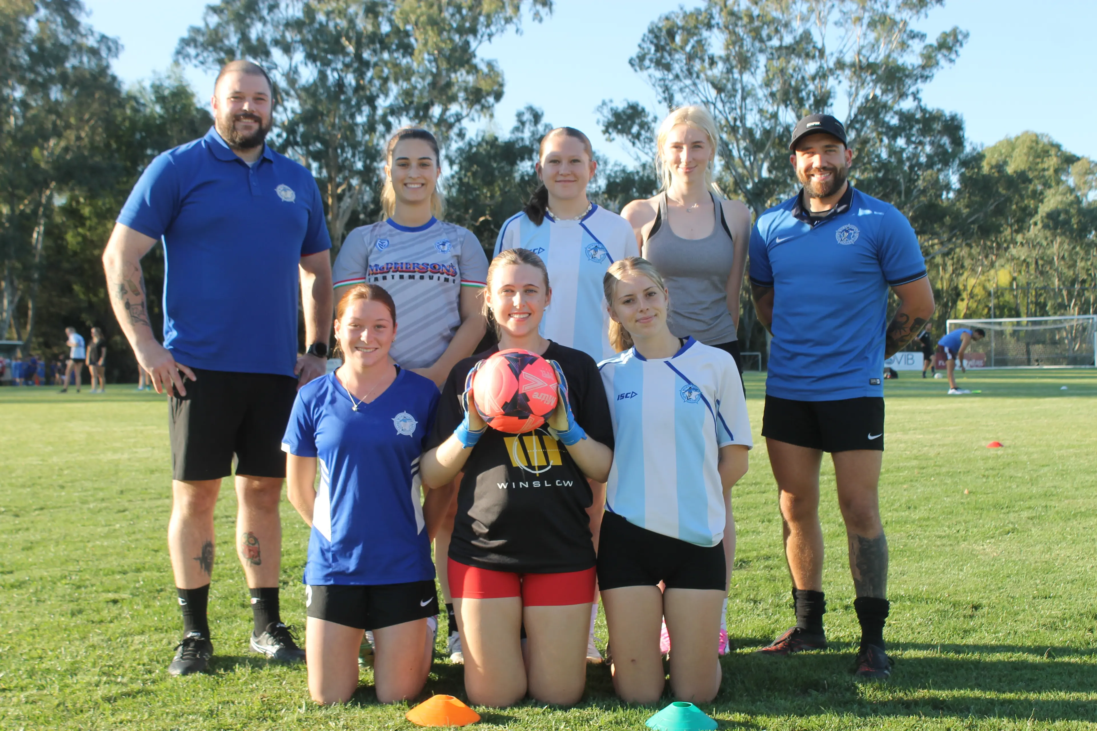 <p>READY TO PLAY: (back, from left) Senior women\\'s co-coach Will Robinson-Dunn, Alessia Colanzi, Kobe Chisholm, Georgia McGuffie, co-coach Tom Scott, (front, from left) Lily Notarianni, Sophia Roso, and Mair Williamson are excited to commence the season this weekend. PHOTO: Phoebe Morgan</p>\\n