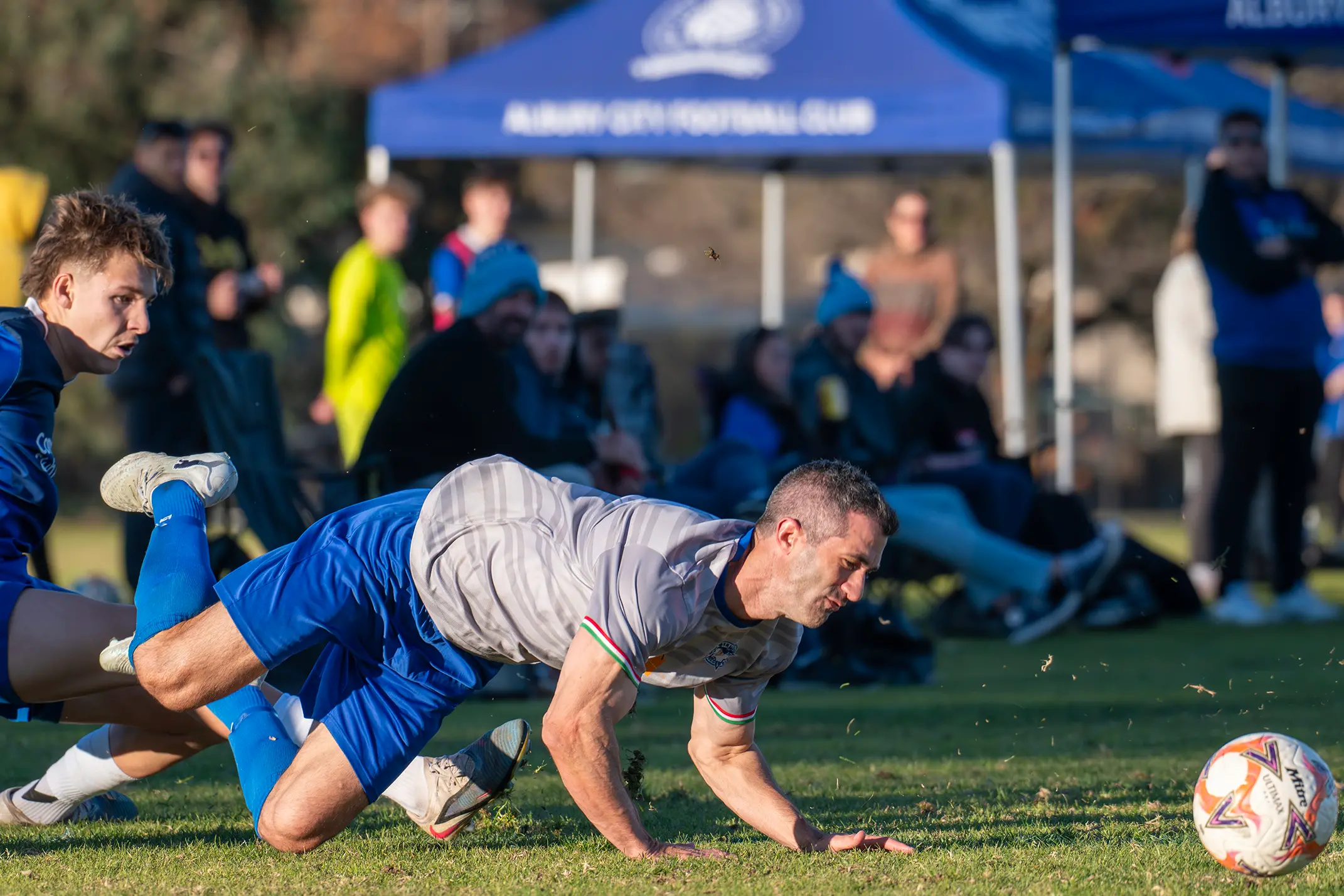 <p>MAN DOWN: Matthew Vaccaro goes down after an Albury City challenge during Myrtleford\\'s 5-0 loss to top of the table Albury City on Sunday. PHOTOS: Melissa Beattie</p>\\n