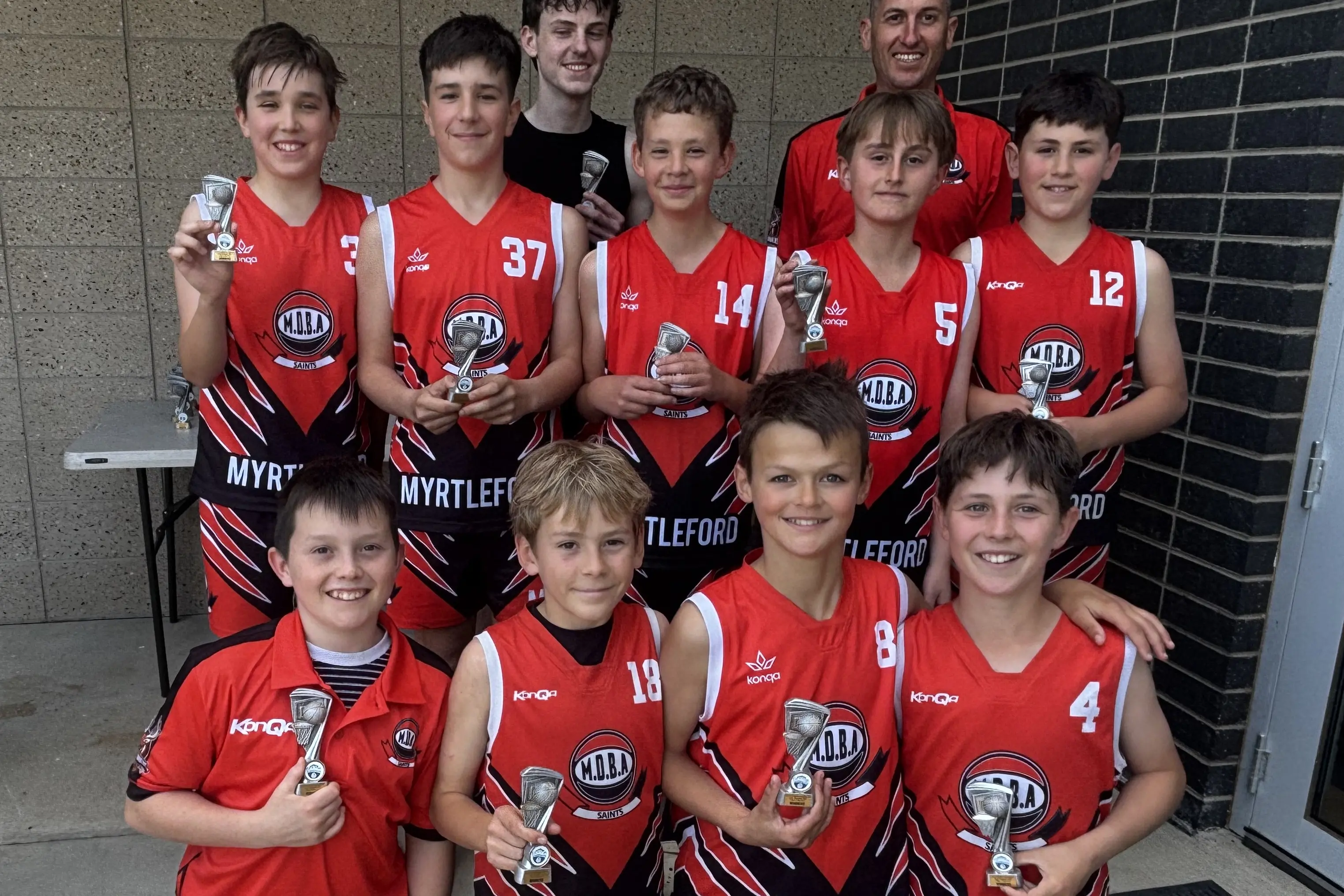 <p>CHAMPIONS: The tournament-winning Myrtleford under 14 side of (back, from left) Quinn Pawlick, Luca Zamperoni, Coach Leonard Cioli (rear), Lachlan Jackson, Owen Saunier, team manager Blair Godenzi, Billy Godenzi, (front, from left) Mason Batt, Bowie Cartwright, Harry Waymouth and Paddy Millar. PHOTO: Jenny Zamperoni.</p>\\n
